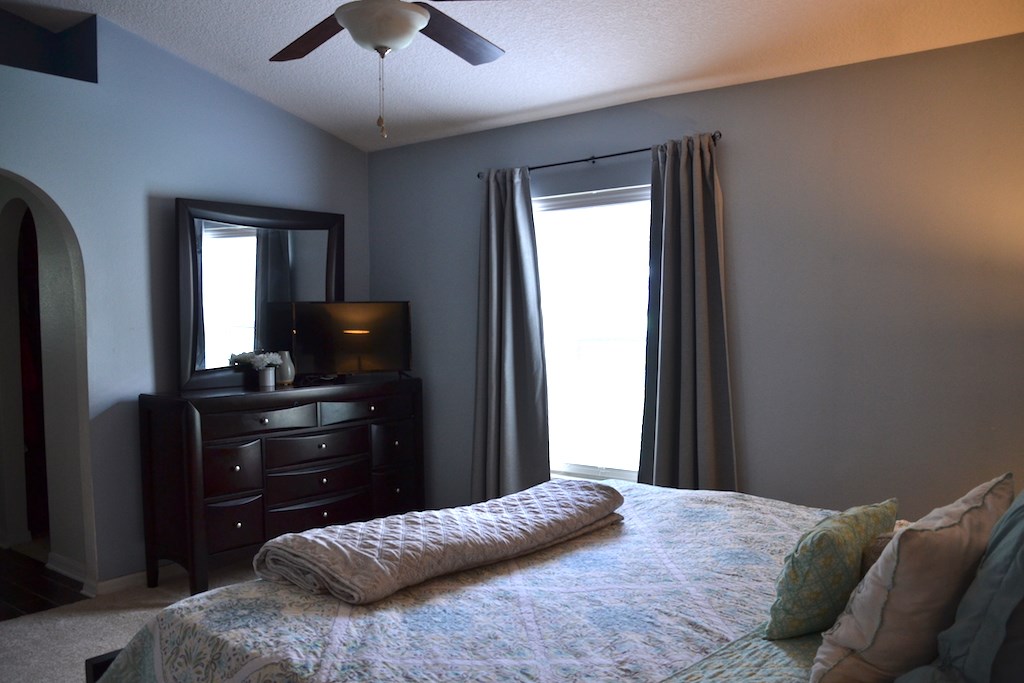 76564 Longleaf Loop Yulee, FL 32097 - Photo 14 of 27 a bedroom with a bed and a flat tv screen on a dresser