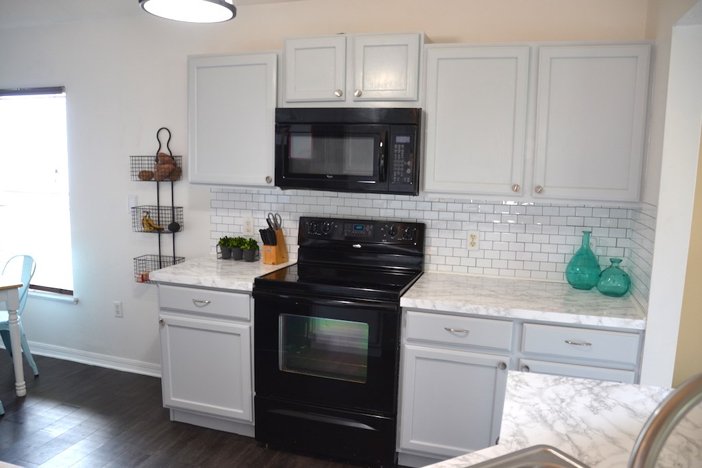 76564 Longleaf Loop Yulee, FL 32097 - Photo 2 of 27 a kitchen with a stove and a microwave