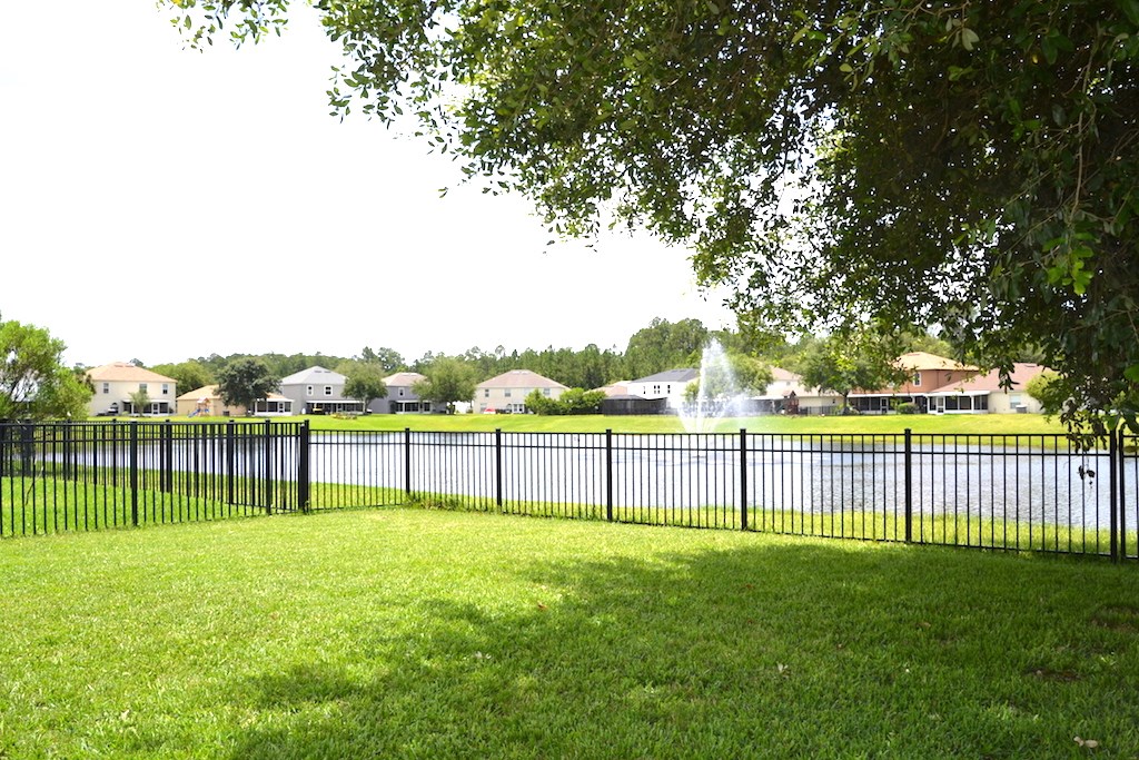 76564 Longleaf Loop Yulee, FL 32097 - Photo 23 of 27 a view of a yard with a fence and trees
