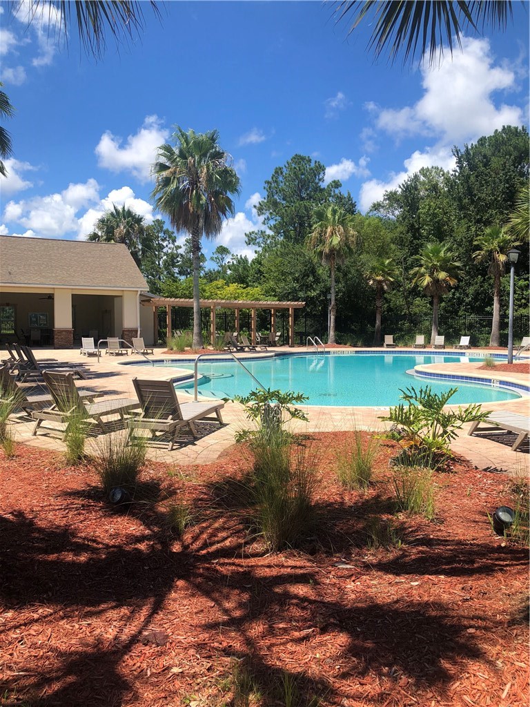 76564 Longleaf Loop Yulee, FL 32097 - Photo 25 of 27 a view of a house with backyard and sitting area
