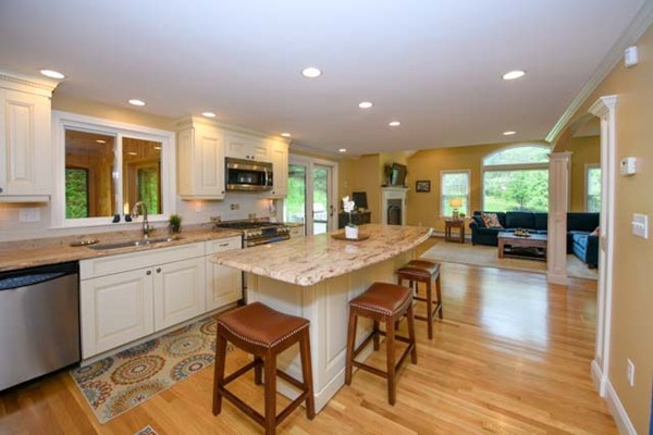 a kitchen with center island and stainless steel appliances