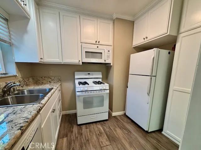 a kitchen with a refrigerator sink and cabinets