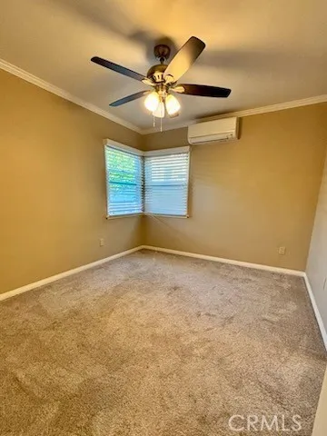 an empty room with a ceiling fan and window