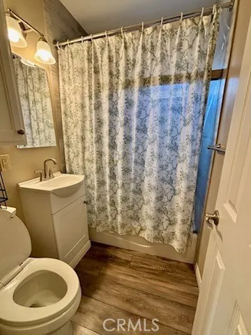 a white toilet sitting next to a shower curtain