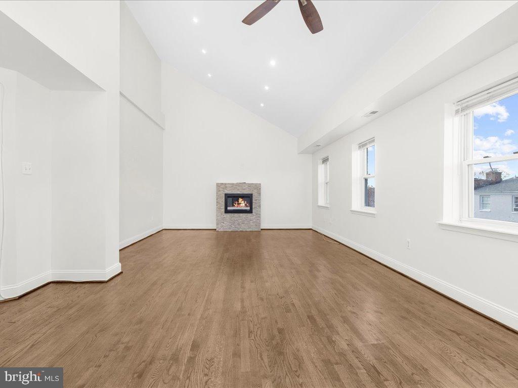 723 South Charles Street, Unit 306 Baltimore, MD 21230 - Photo 11 of 23 an empty room with wooden floor and windows
