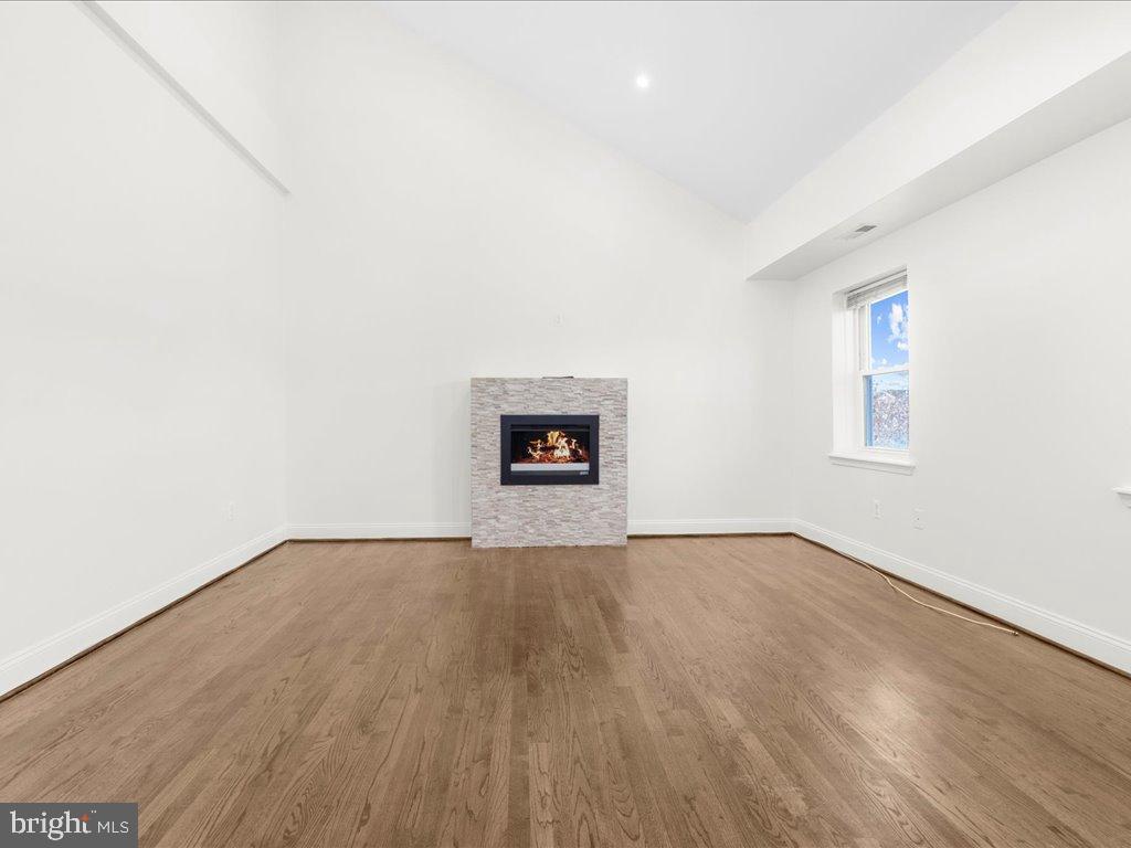 723 South Charles Street, Unit 306 Baltimore, MD 21230 - Photo 12 of 23 an empty room with wooden floor and a window