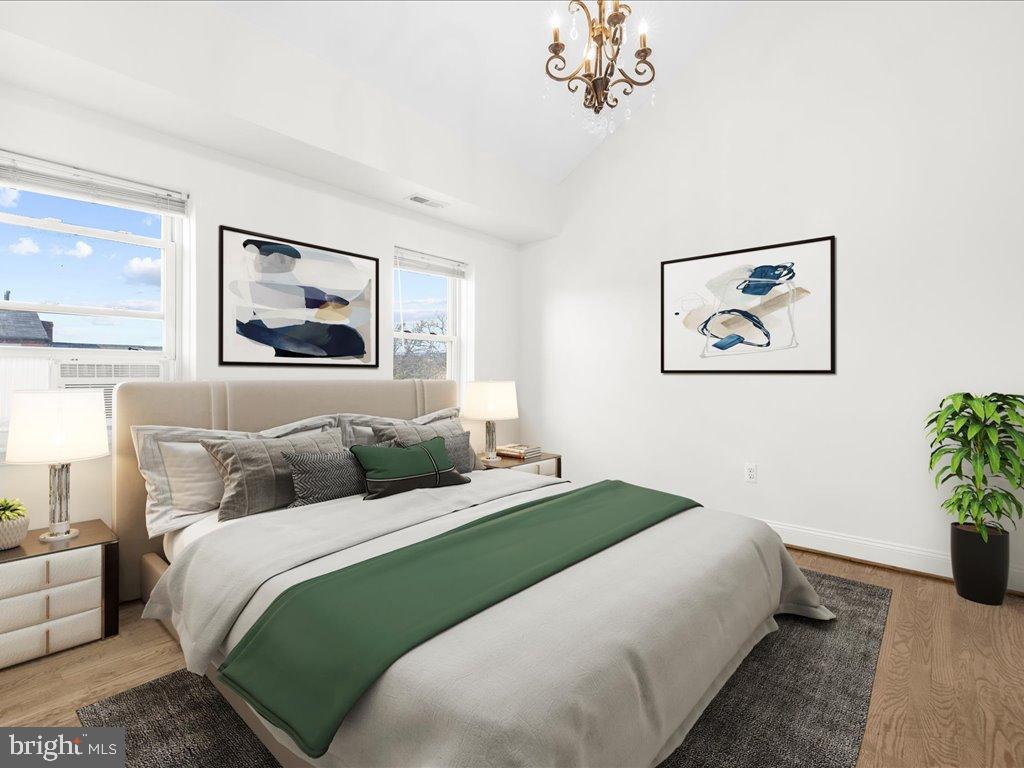 723 South Charles Street, Unit 306 Baltimore, MD 21230 - Photo 15 of 23 a bedroom with bed and painting on the wall