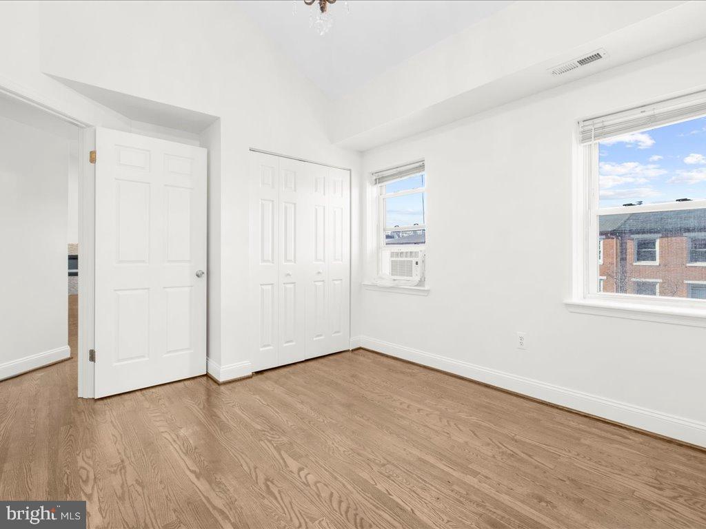 723 South Charles Street, Unit 306 Baltimore, MD 21230 - Photo 18 of 23 a view of empty room with wooden floor and fan