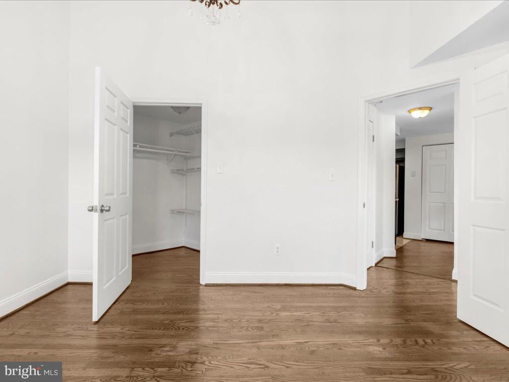 723 South Charles Street, Unit 306 Baltimore, MD 21230 - Photo 19 of 23 a view of an empty room with wooden floor and a hallway