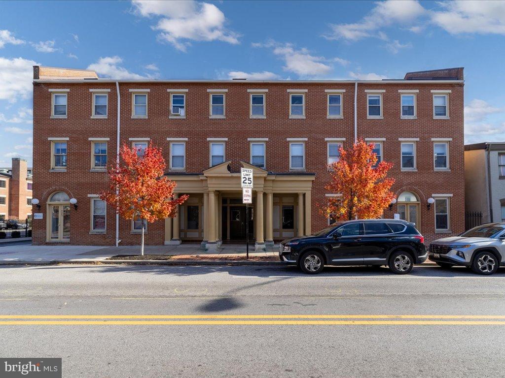723 South Charles Street, Unit 306 Baltimore, MD 21230 - Photo 2 of 23 a couple of cars parked in front of a building
