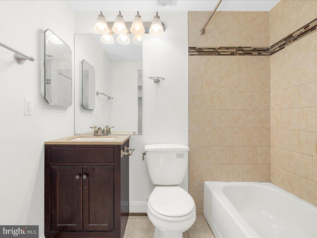 723 South Charles Street, Unit 306 Baltimore, MD 21230 - Photo 21 of 23 a bathroom with a sink a toilet and shower