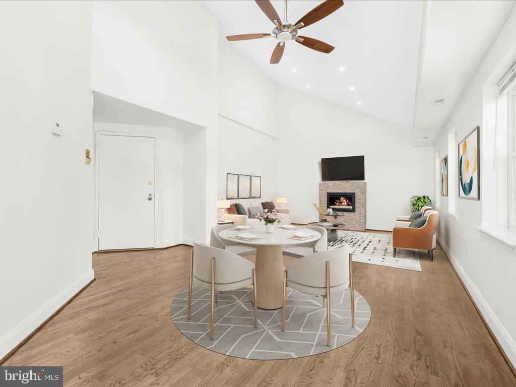723 South Charles Street, Unit 306 Baltimore, MD 21230 - Photo 5 of 23 a dining room with wooden floor a chandelier fan a wooden table and chairs