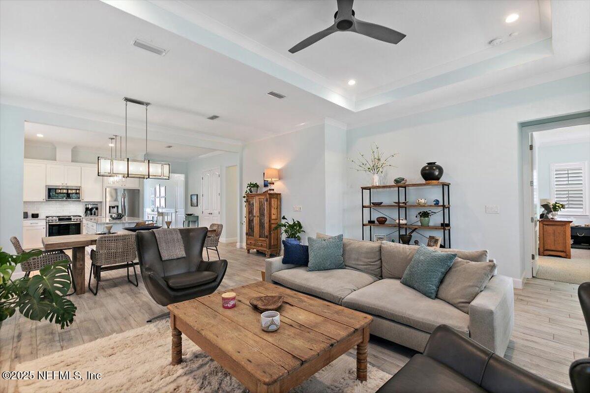 175 Oceanview Drive St. Augustine, FL 32080 - Photo 16 of 56 a living room with furniture a chandelier and a dining table