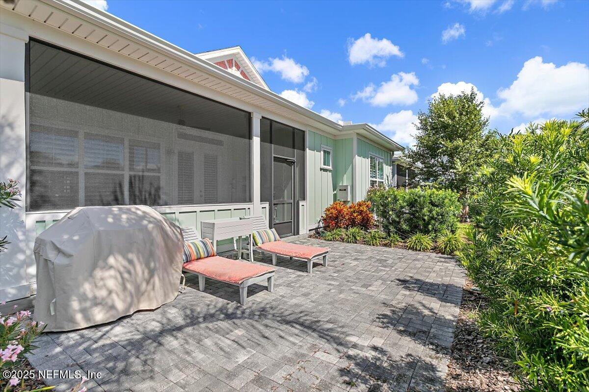 175 Oceanview Drive St. Augustine, FL 32080 - Photo 31 of 56 a backyard of a house with table and chairs and potted plants