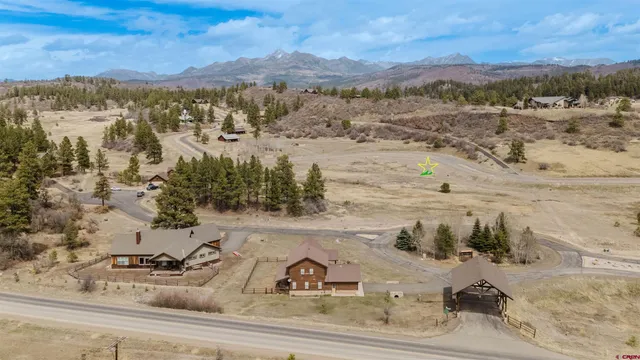 a view of a brick wall with a building in the background