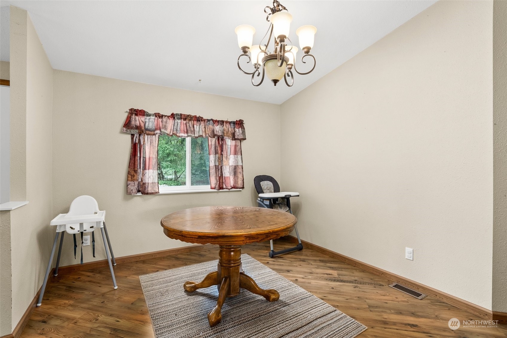 13434 Marcon Lane Southwest Rochester, WA 98579 - Photo 13 of 38 a view of a room with a table chair and wooden floor