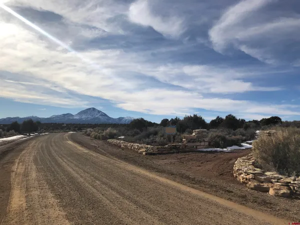 a view of a street with a mountain in the background