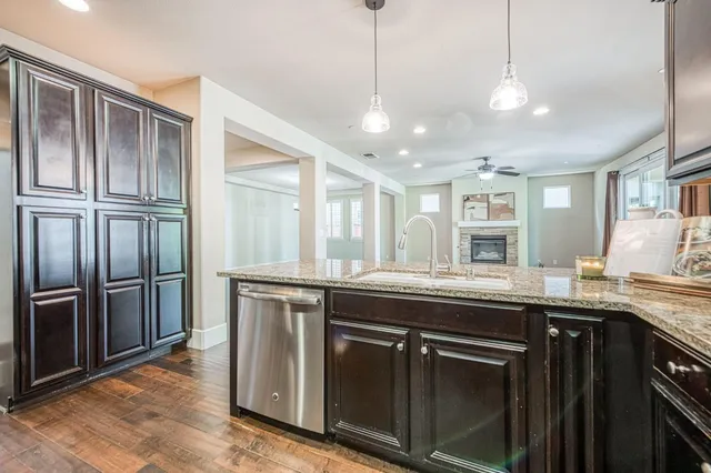 a spacious bedroom with a large bed a flat screen tv and couches