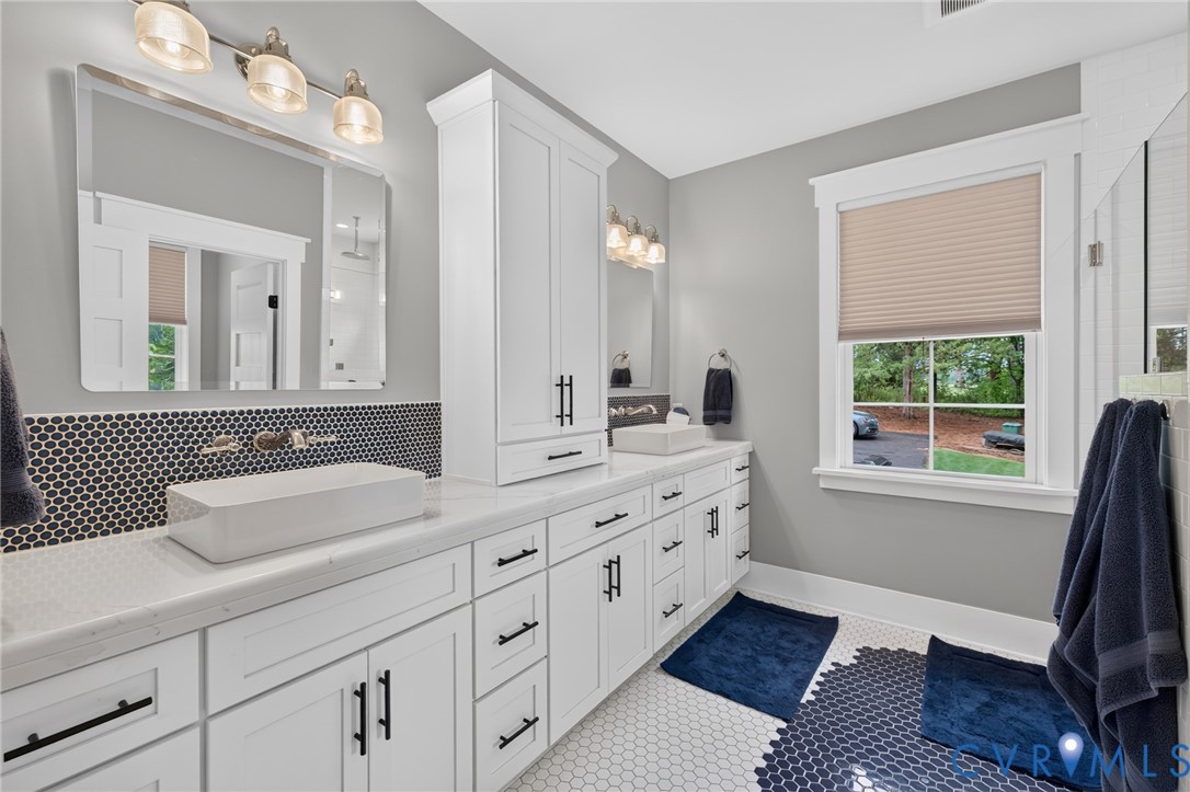 2122 Jockey Ridge Road Maidens, VA 23102 - Photo 32 of 63 a bathroom with double vanity sink a mirror and a window