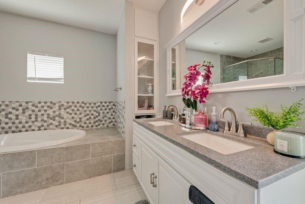 610 Ewing Road Ferris, TX 75125 - Photo 15 of 22 Dual vanity with integrated sinks and a stone-finish countertop