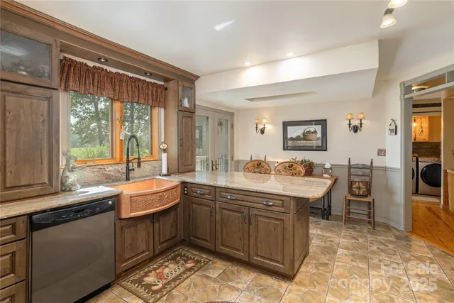 a kitchen with a sink and large window