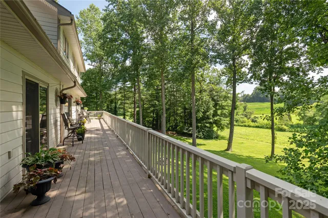 a view of balcony with wooden floor and fence
