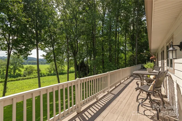 a view of balcony with wooden floor and fence