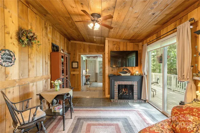 a living room with furniture a fireplace and a chandelier