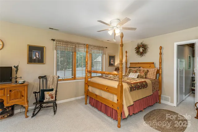 a bed room with a bed and a chandelier