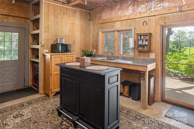 a kitchen with a sink stove and cabinets