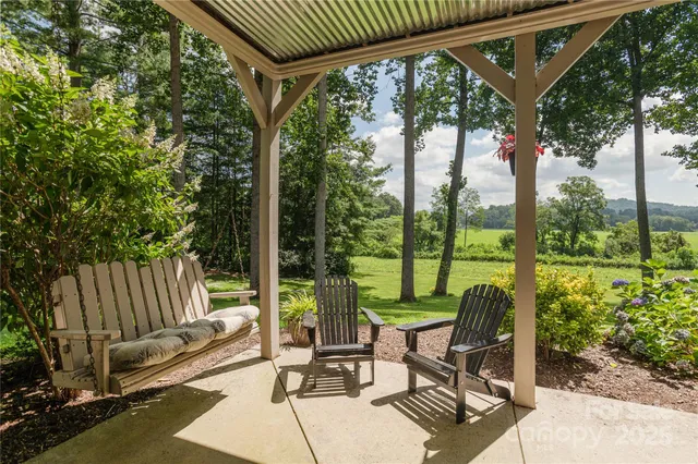 a view of a patio with a table chairs and a backyard
