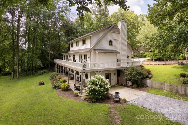 a view of a house with a yard and sitting area