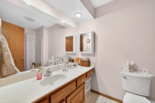 a bathroom with a sink vanity and a mirror