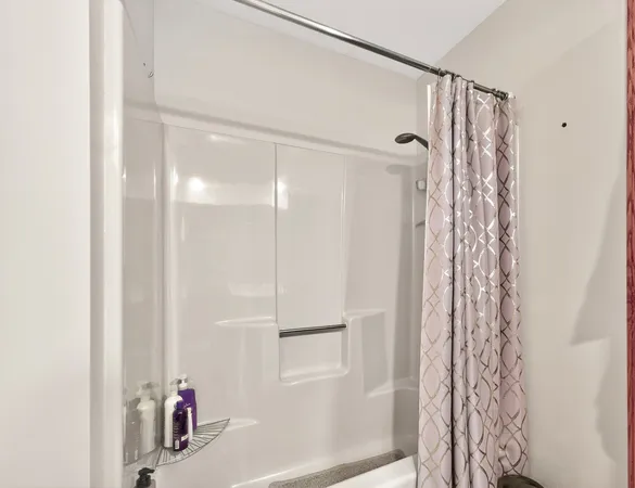 a bathroom with a shower and a sink
