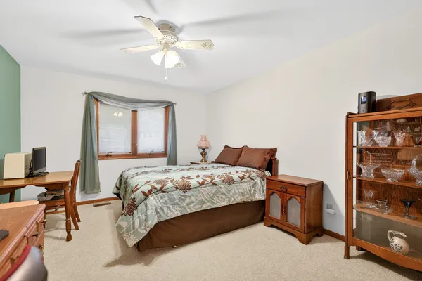 a bedroom with bed and a chandelier
