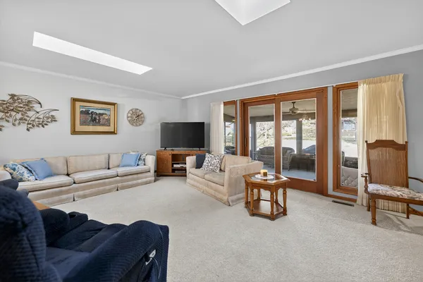a living room with furniture and large flat screen tv