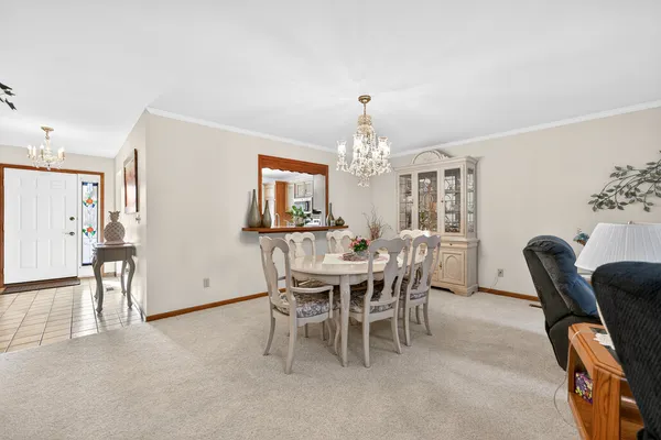 a view of a dining room with furniture and chandelier