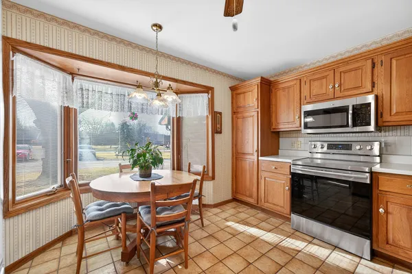 a dining room with furniture a fireplace and wooden floor