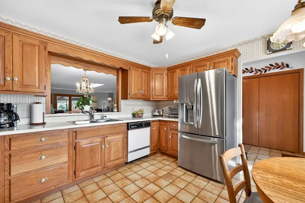a kitchen with a refrigerator a sink and cabinets