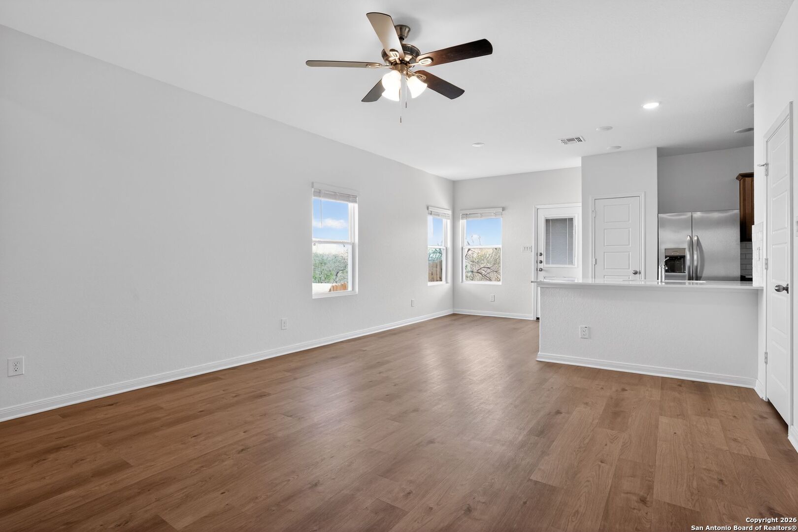 5402 Devils Gate, Unit 1 Converse, TX 78109 - Photo 12 of 20 a view of an empty room with window and wooden floor