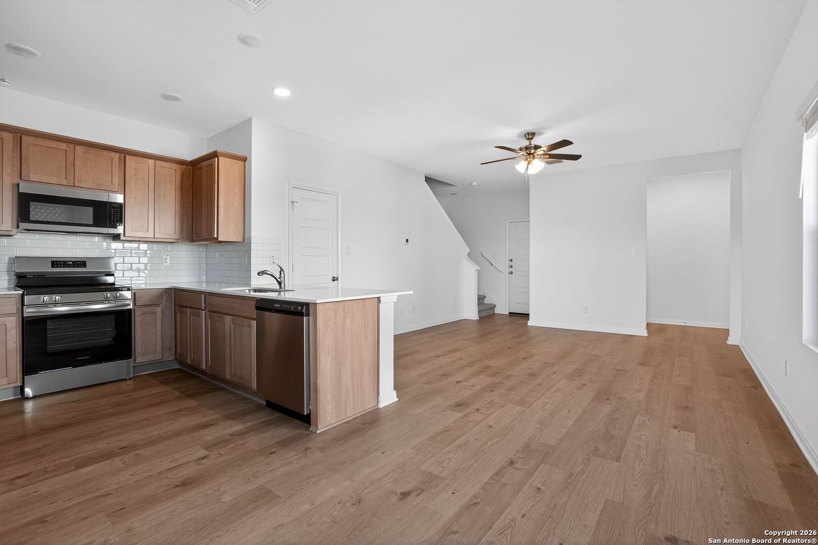 5402 Devils Gate, Unit 1 Converse, TX 78109 - Photo 4 of 20 a kitchen with stainless steel appliances sink a microwave and cabinets