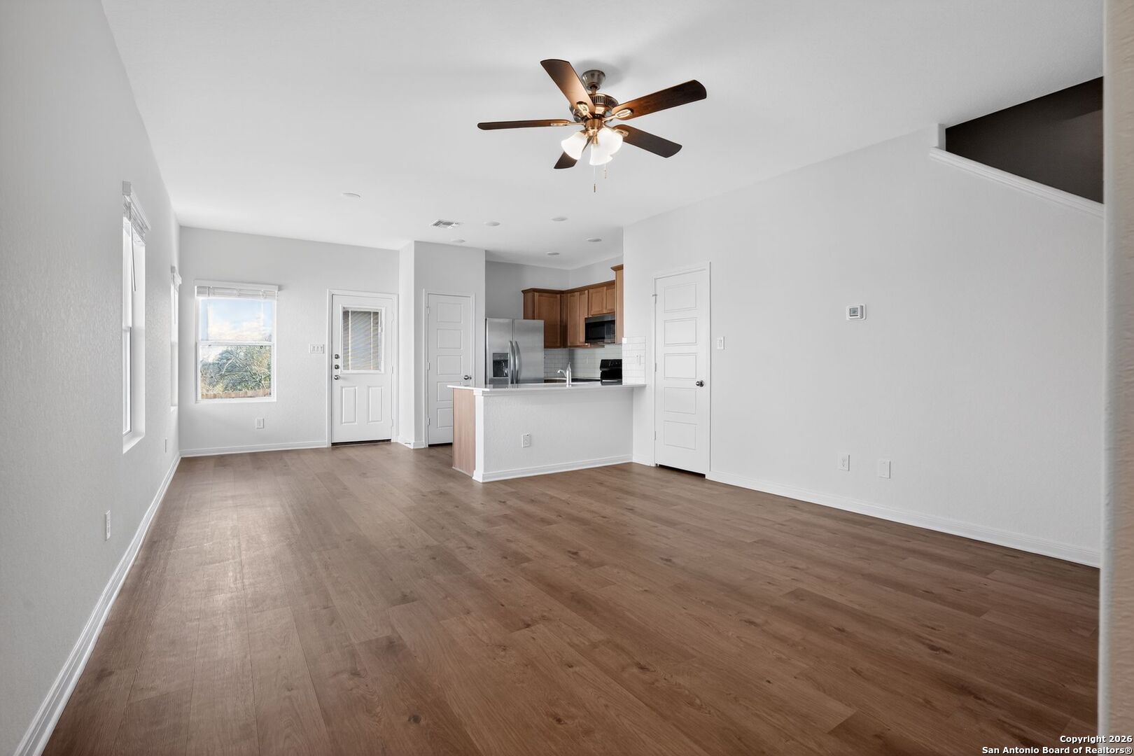 5402 Devils Gate, Unit 1 Converse, TX 78109 - Photo 6 of 20 a view of empty room with wooden floor and ceiling fan