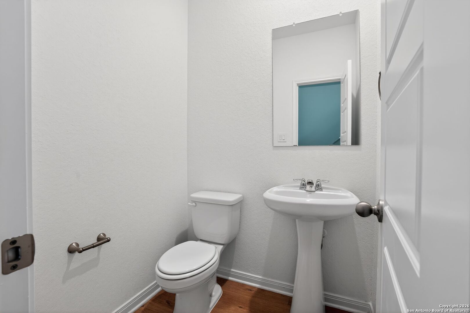 5402 Devils Gate, Unit 1 Converse, TX 78109 - Photo 7 of 20 a bathroom with a toilet sink and mirror