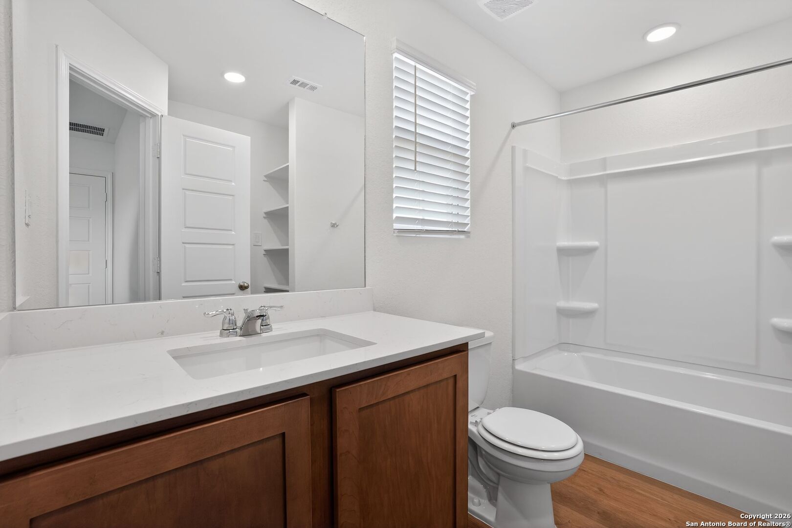 5402 Devils Gate, Unit 1 Converse, TX 78109 - Photo 9 of 20 a bathroom with a sink toilet a mirror and shower