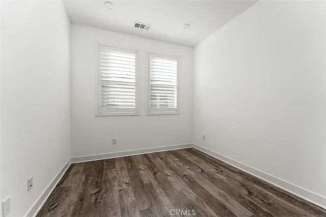 a bathroom with a toilet a sink a mirror a bathtub and vanity