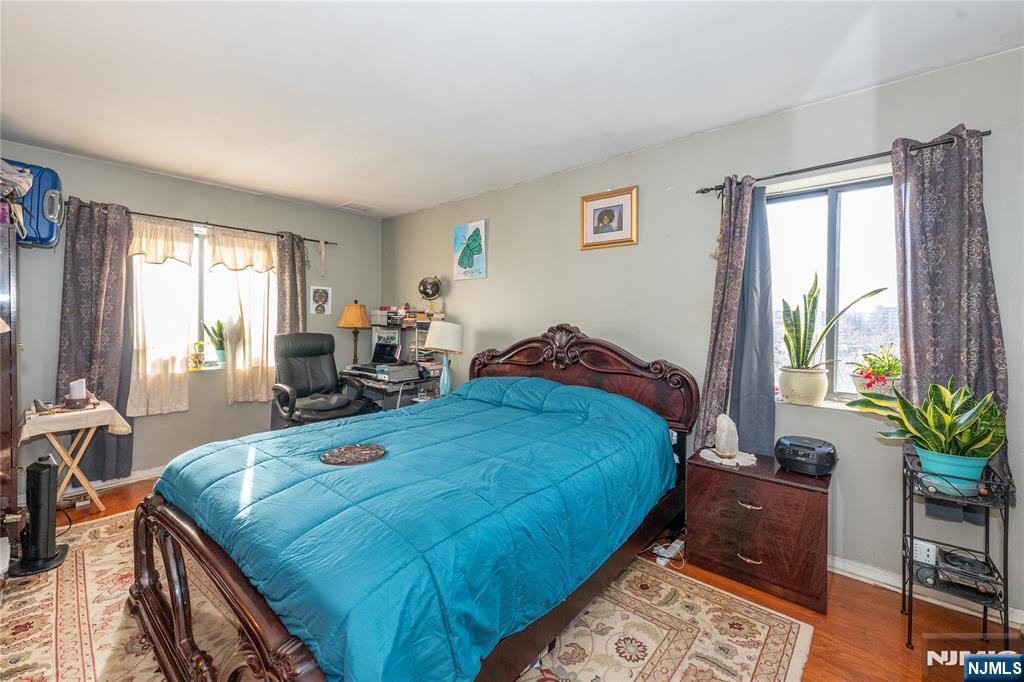 75 Union Street, Unit 5E Hackensack, NJ 07601 - Photo 19 of 24 a bed sitting in a bedroom next to a window