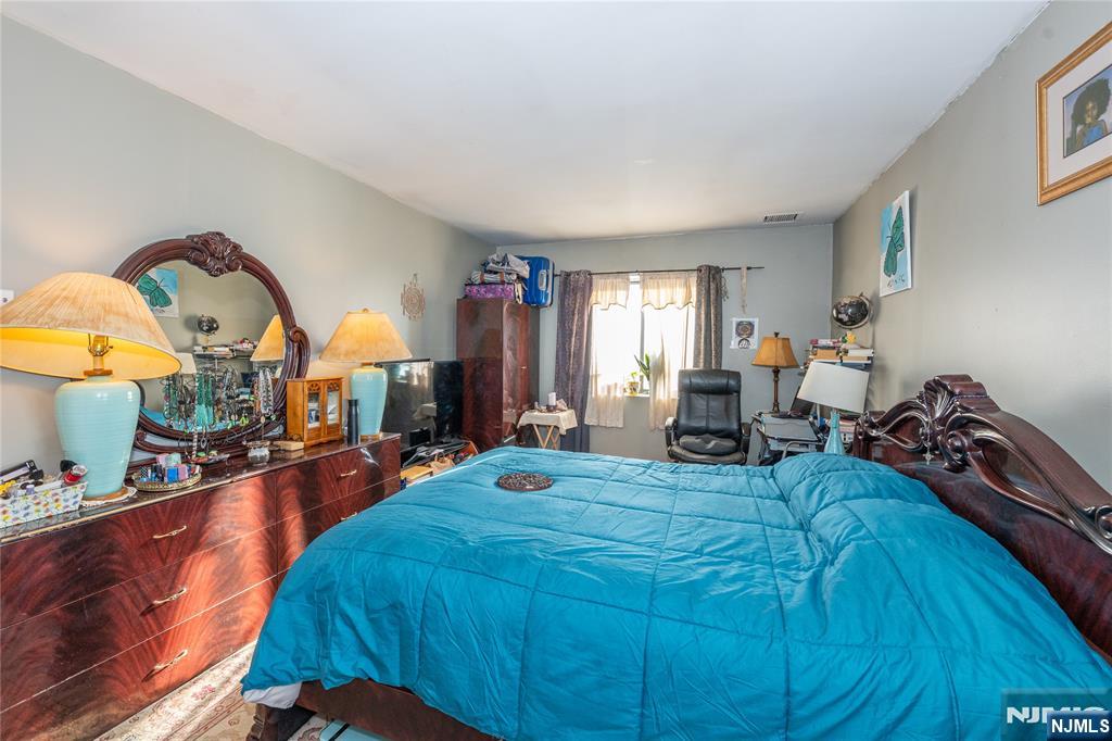 75 Union Street, Unit 5E Hackensack, NJ 07601 - Photo 20 of 24 a bed room with a bed and a chandelier