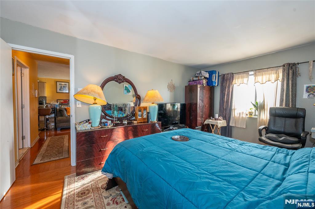 75 Union Street, Unit 5E Hackensack, NJ 07601 - Photo 21 of 24 a bedroom with a bed a mirror and dresser