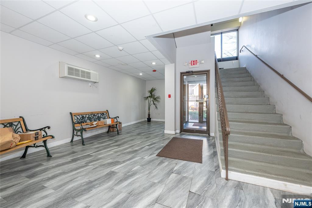 75 Union Street, Unit 5E Hackensack, NJ 07601 - Photo 5 of 24 a view of a hallway with wooden floor and furniture