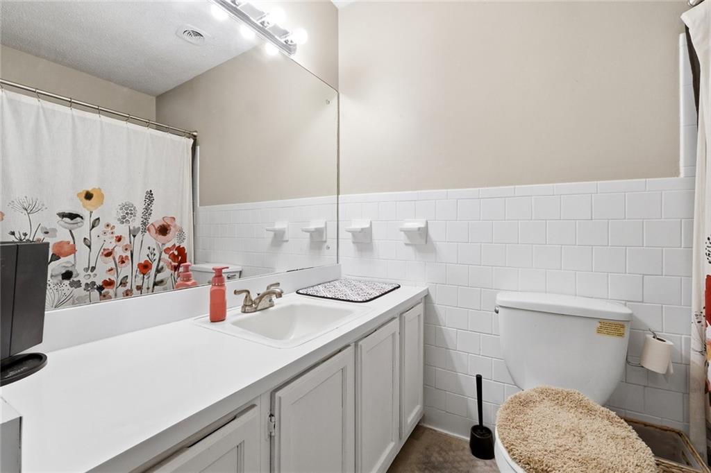 1619 Ridgeview Drive Northwest Conyers, GA 30012 - Photo 13 of 20 a bathroom with a sink toilet and vanity